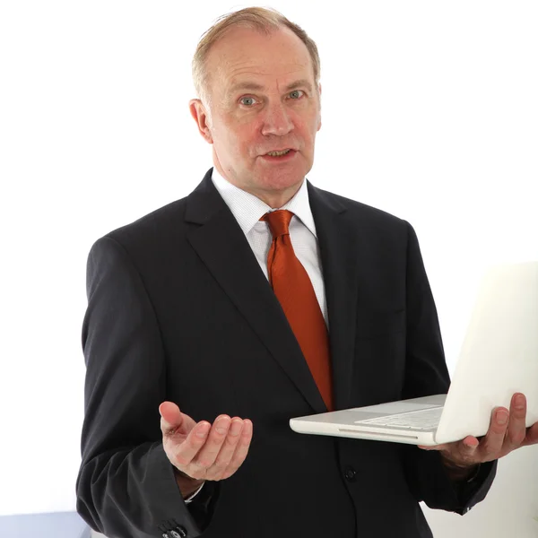 Persuasive businessman holding laptop — Stock Photo, Image