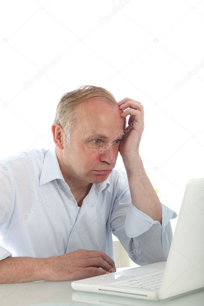 Frustrated bemused man with laptop