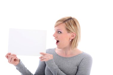 Woman with surprised expression holding sign clipart