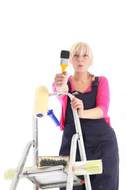 Female decorator on a ladder clipart