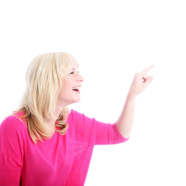 Mulher rindo apontando para espaço em branco — Fotografia de Stock