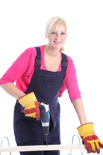 Woman carpenter using a power drill — Stock Photo, Image