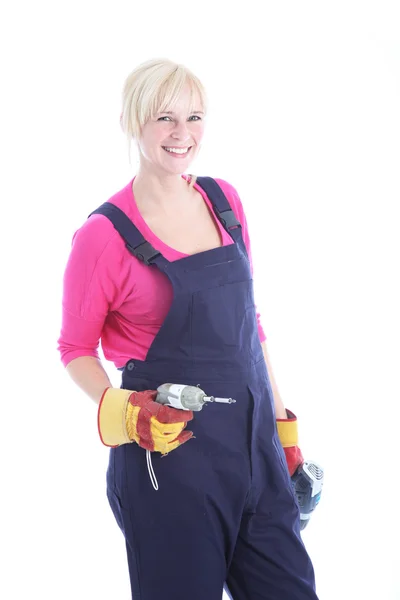 Mulher trabalhadora sorridente com uma broca — Fotografia de Stock
