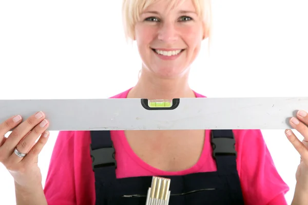Female worker with a spirit level — Stock Photo, Image