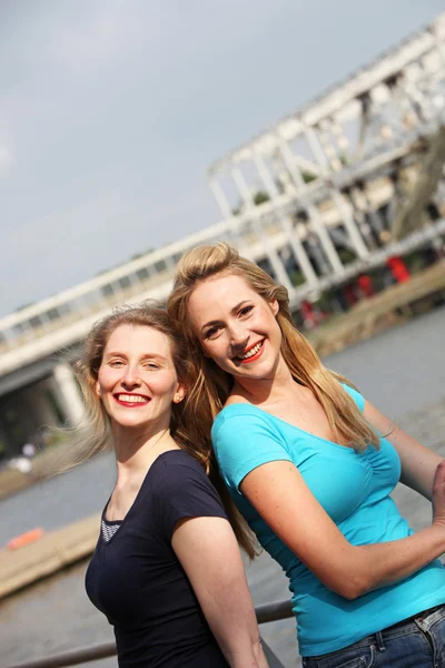 Happy women on an urban waterfront — Stockfoto