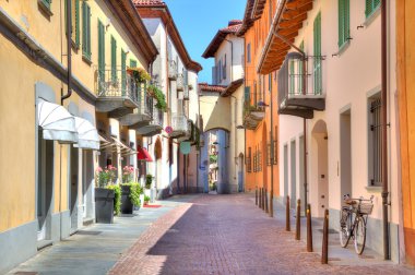 Old colorful street in Alba, Northern Italy. clipart