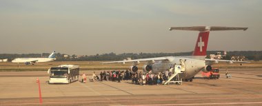 Passengers boarding at Malpensa airport. clipart