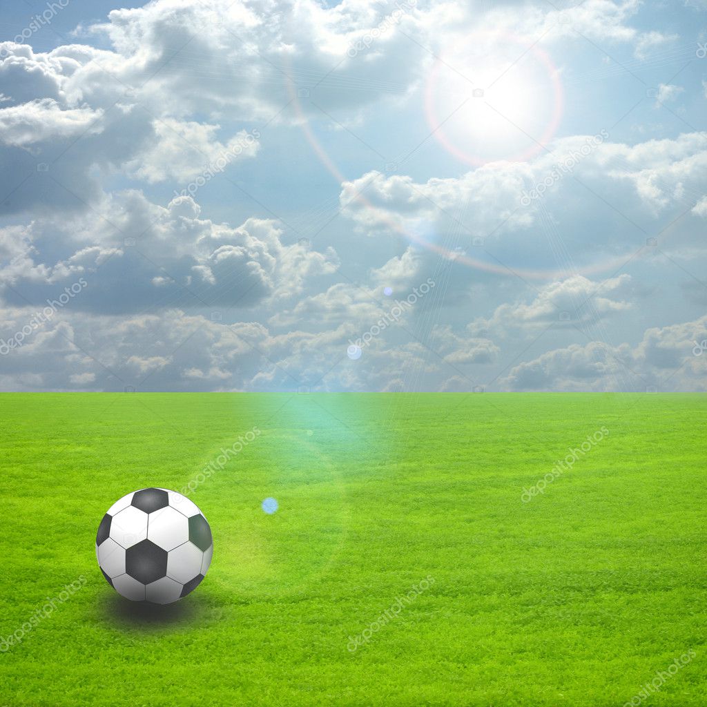 Soccer ball on the green field with sun set — Stock Photo © osalenko ...