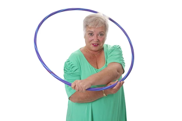 Senior lady doing gymnastic with hula-hoop — Stock Photo, Image