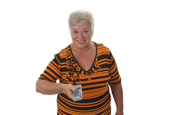 Femme senior zapping avec télécommande — Photo