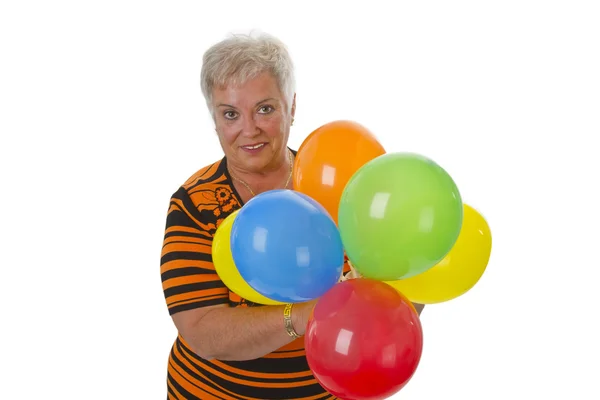 Kadın kıdemli renkli balonlar ile — Stok fotoğraf