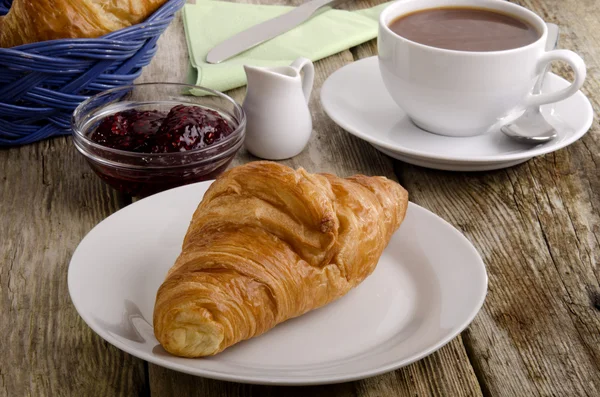 Croissant, a French breakfast on a plate — Stock Photo, Image