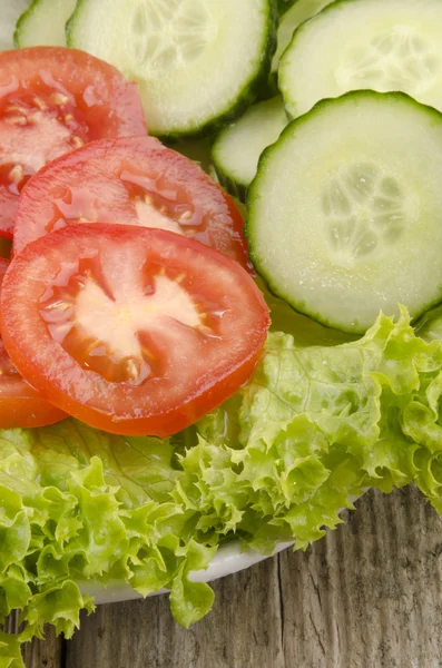 Fresh salad with tomato and cucumber slices — Stock Photo, Image