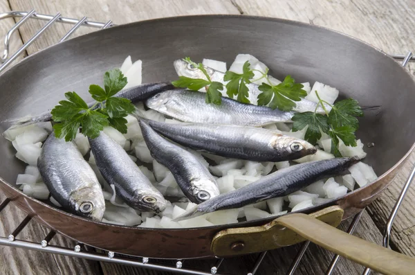 Sprat with onions in a pan — Stock Photo, Image