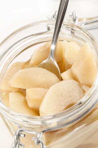Pickled split pear and a spoon — Stock Photo, Image