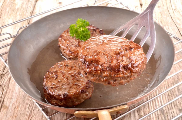 Fried hamburger meat in a copper pan — Stock Photo, Image