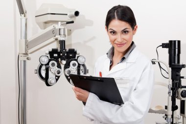 Smiling Young Optometrist With Clipboard clipart