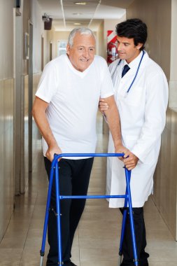 Doctor Assisting Old Man On a Walker clipart