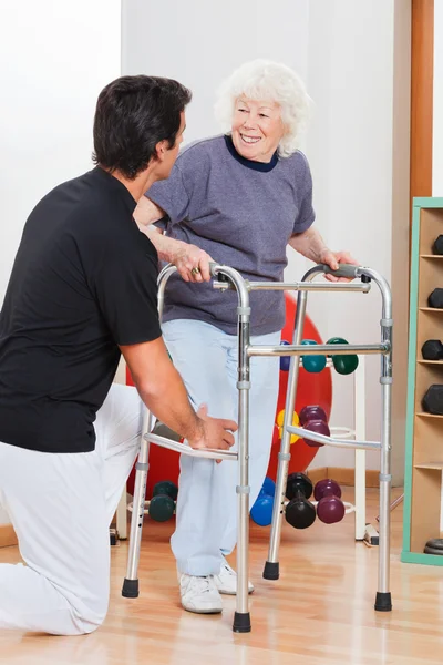 Woman With Walker Looking At Trainer — Stock Photo, Image
