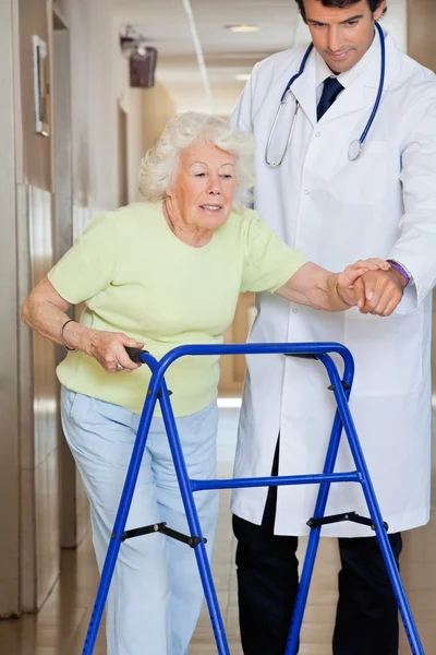 Arts tonen weg aan de patiënt met behulp van walker — Stockfoto