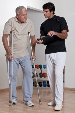 Patient on Crutches and Physician clipart