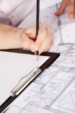 Architects Hand on Clipboard clipart