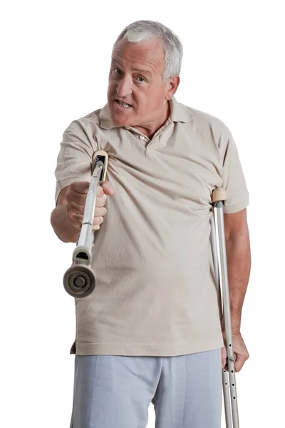 Muž, držící berlu jako zbraň — Stock fotografie