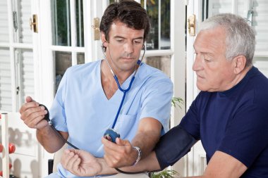 Doctor taking the Blood Pressure clipart