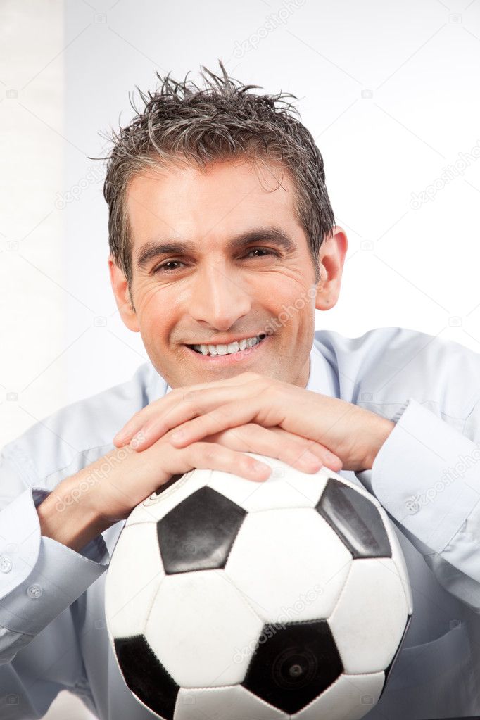 Businessman with Football at Work