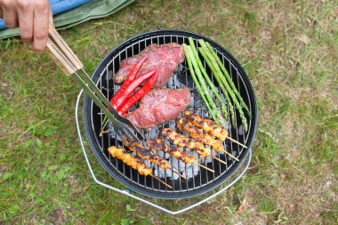 Meat And Veggies Cooking On Barbecue clipart