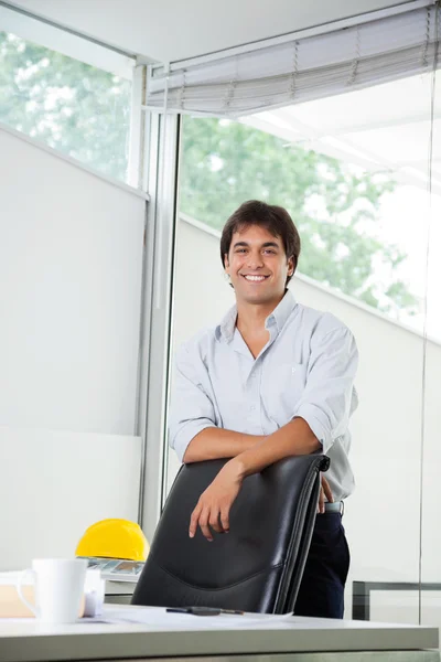 Architect Standing By Office Chair Royalty Free Stock Photos