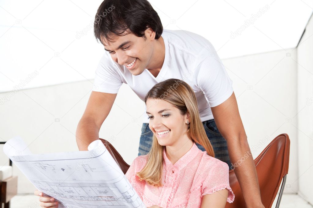 Young Couple Looking at Blueprints