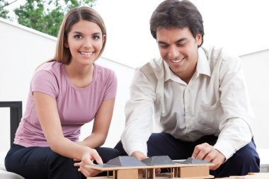 Two Architects Building a House Model clipart