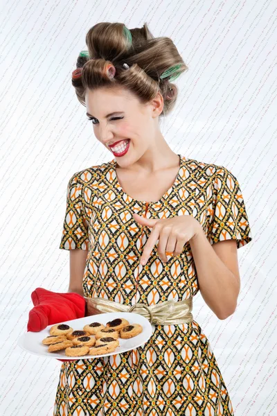 Nő szempillantás mint ő tartja a lemezt a cookie-k — Stock Fotó