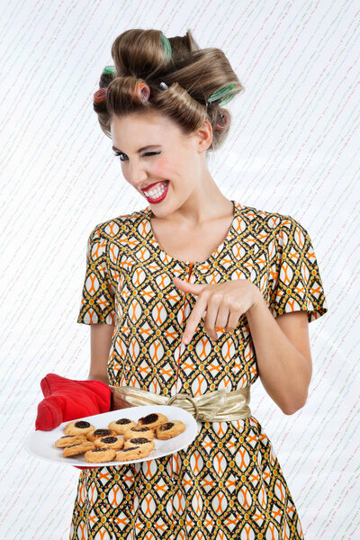 Woman Winks As She Holds Plate Of Cookies