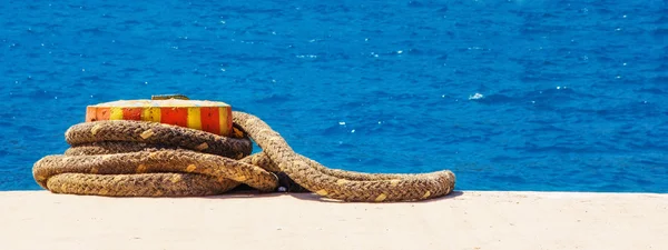 stock image Rope tied around a mooring bollard