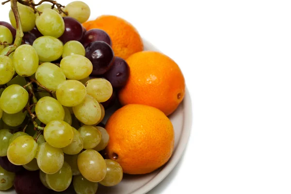 Vindruvor och apelsiner — Stockfoto
