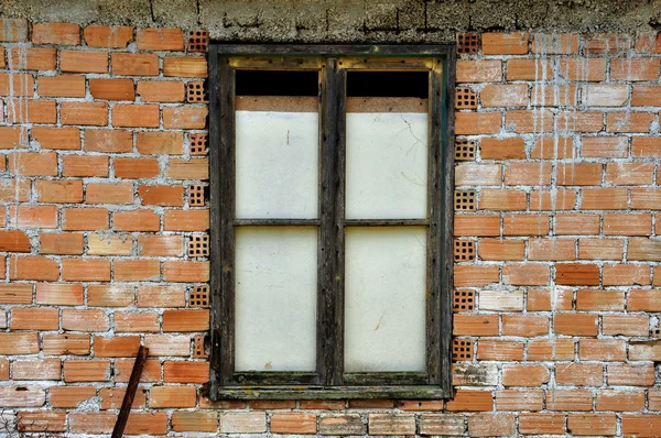 Stained brick wall and boarded up window — Stock Photo, Image