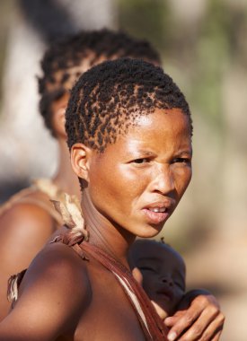 Young bushman woman with child clipart