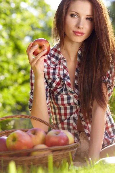 Beautifuwoman en el jardín con manzanas — Foto de Stock