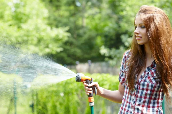 Jardin d'été herbe femme jouer avec tuyau d'eau journée ensoleillée — Photo