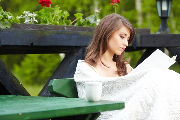Mujer joven con taza al aire libre — Foto de Stock