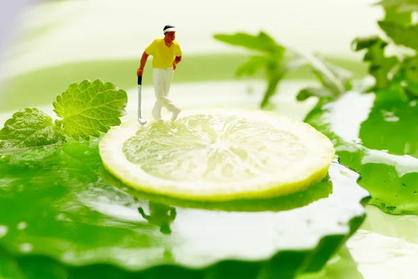 stock image Miniature Figures playing golf on fruits