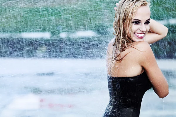 Genç seksi kız ıslak yağmurda sokak boyunca yürüyüş — Stok fotoğraf
