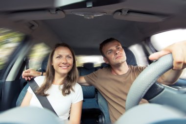 Young couple in a car clipart