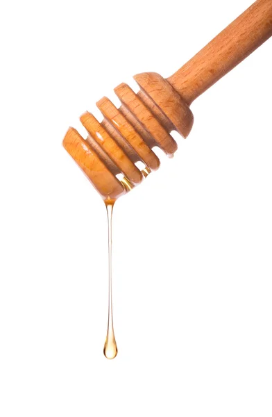 stock image Honey dripping from a wooden dipper