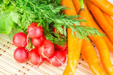 Fresh carrots and radishes with tops clipart