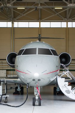 Private Jet in hangar clipart