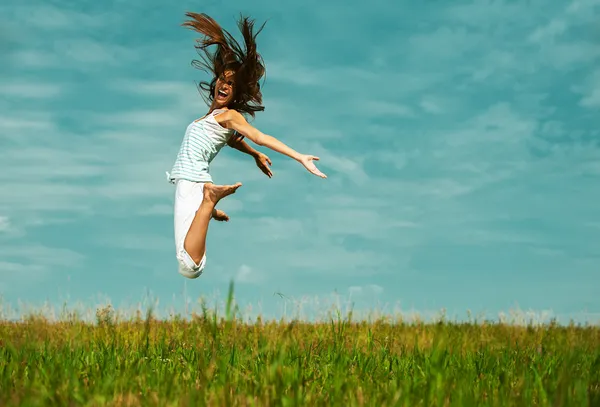 Attractive woman jumping in sky — Stock Photo, Image