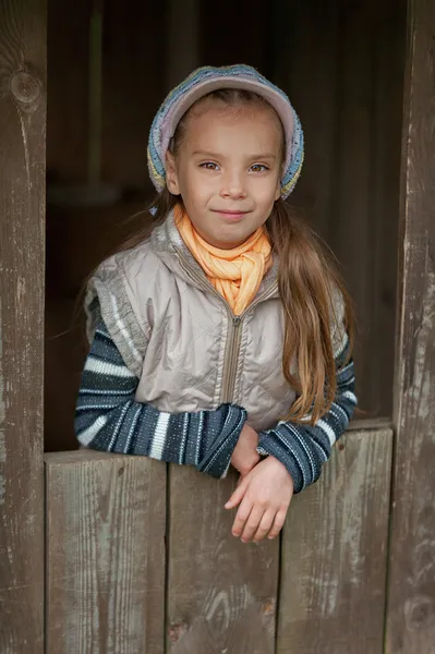 Happy girl-preschooler in wooden hut — Stock Photo, Image